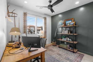 Office featuring hardwood / wood-style floors and ceiling fan