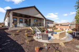 Rear view of property featuring ceiling fan, an outdoor living space, central AC unit, and a patio