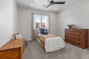 Bedroom with light carpet and ceiling fan