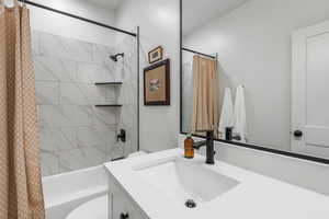 Full bathroom featuring vanity, toilet, and shower / bath combo with shower curtain