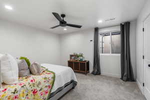 Bedroom featuring ceiling fan and light carpet