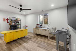 Office featuring ceiling fan and light hardwood / wood-style floors