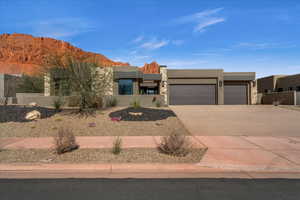 Pueblo revival-style home featuring a mountain view and a garage