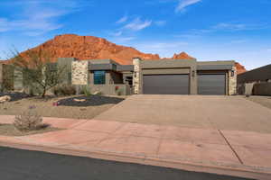 View of front of property featuring a garage and a mountain view