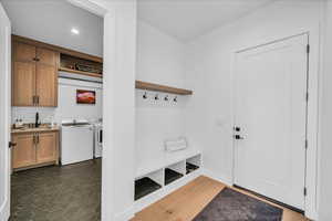 Mudroom with separate washer and dryer and sink