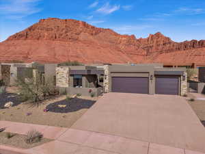 View of front of property with a mountain view and a garage