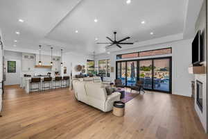 Living room featuring ceiling fan and light hardwood / wood-style floors