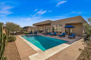 View of swimming pool with an in ground hot tub, outdoor lounge area, and a patio area