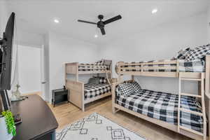 Bedroom with ceiling fan and light hardwood / wood-style flooring