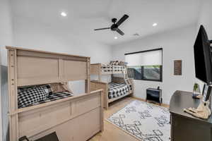 Bedroom featuring ceiling fan and light hardwood / wood-style flooring