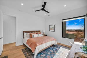 Bedroom with ceiling fan and light hardwood / wood-style floors