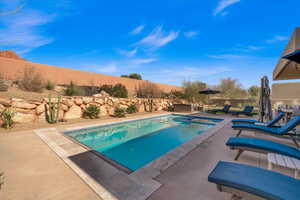 View of pool featuring an in ground hot tub and a patio area