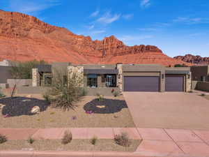 View of front facade with a garage and a mountain view