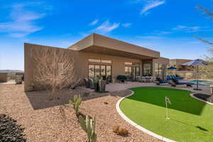 Rear view of house featuring a fenced in pool and a patio