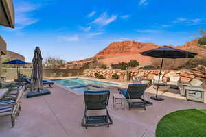 View of swimming pool with a mountain view and a patio area