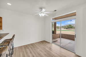 Unfurnished dining area with ceiling fan and light hardwood / wood-style flooring