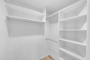 Walk in closet featuring hardwood / wood-style flooring