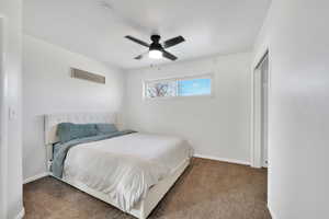 Carpeted bedroom with ceiling fan