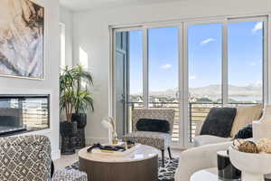 Living room featuring a mountain view, plenty of natural light, and hardwood / wood-style floors