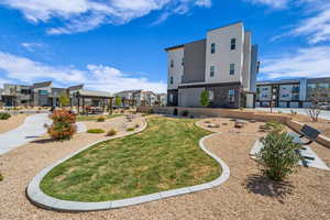 View of home's community with a lawn