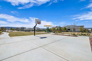 View of sport court featuring a playground and a yard