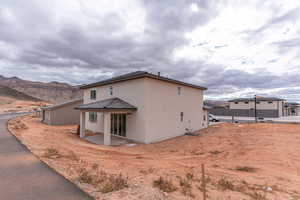 Back of property with a mountain view