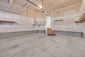 Garage featuring a garage door opener