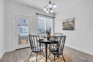 Dining room featuring an inviting chandelier and light hardwood / wood-style flooring