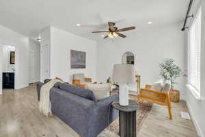 Living room featuring light hardwood / wood-style floors and ceiling fan