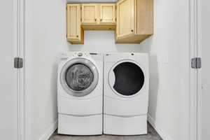 Clothes washing area with cabinets and washing machine and clothes dryer