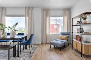 Living area with a wealth of natural light and wood-type flooring