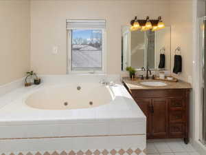 Bathroom with vanity, tile patterned floors, and plus walk in shower