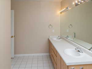 Bathroom featuring tile patterned flooring and vanity