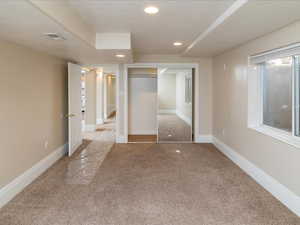 Unfurnished bedroom featuring a closet, carpet, and a textured ceiling