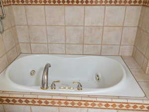 Room details featuring a relaxing tiled tub