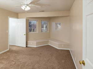 Spare room with carpet flooring and ceiling fan