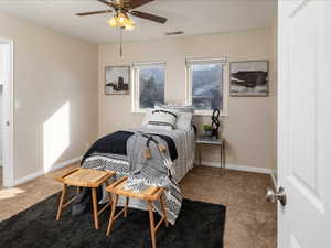 Bedroom featuring ceiling fan and carpet floors