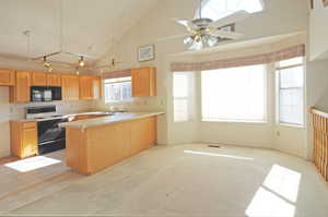 Kitchen featuring sink, high vaulted ceiling, range with electric cooktop, light colored carpet, and kitchen peninsula