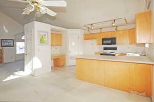 Kitchen with light brown cabinetry, sink, electric range, ceiling fan, and kitchen peninsula