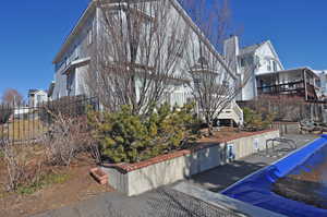 View of home's exterior featuring a covered pool