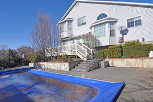 View of swimming pool with a wooden deck