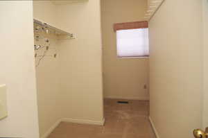 Spacious closet featuring carpet floors