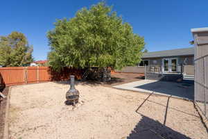 View of yard with a patio, a deck, and an outdoor fire pit