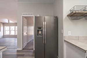 Kitchen featuring dark wood-type flooring and stainless steel fridge