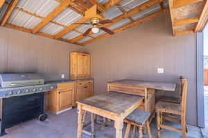 View of patio featuring area for grilling and ceiling fan