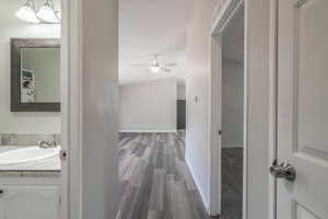 Hall featuring sink and wood-type flooring