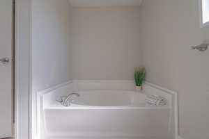 Bathroom featuring a tub to relax in