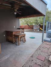 View of patio / terrace featuring a playground and ceiling fan