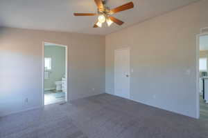 Carpeted empty room with ceiling fan