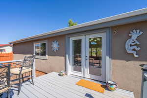 Wooden terrace featuring french doors